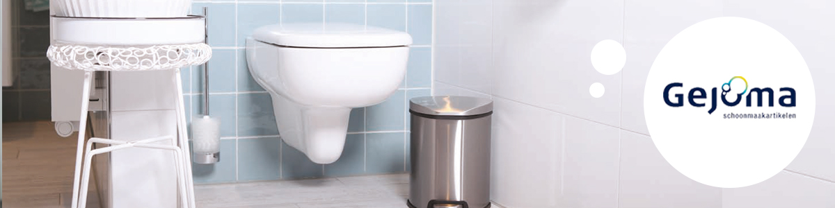 Een klein RVS-afvalbakje die op de grond naast een toilet staat.